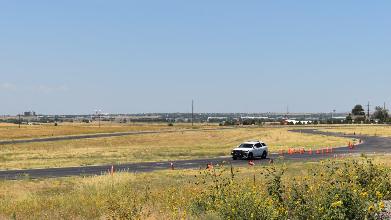 Police vehicle on a rural road training course with traffic cones