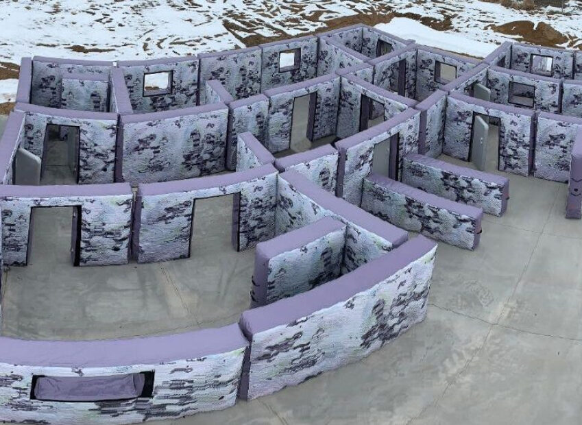 Inflatable and portable walls configured to resemble the interior of a house or building for shooting practice.